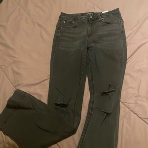 Hight rise boot cut with rips on the knees. Stretchy. More of a faded black look